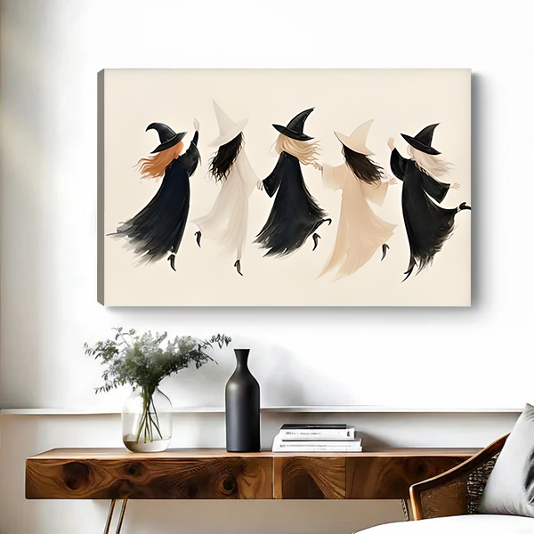 Woman holding framed minimalist witch coven Halloween canvas art featuring flowing black and cream silhouettes