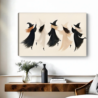 Woman holding framed minimalist witch coven Halloween canvas art featuring flowing black and cream silhouettes