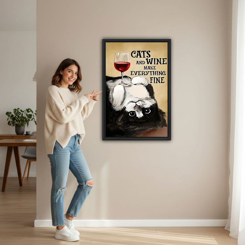 Smiling woman pointing at large cats and wine framed canvas print to show size in bright living room