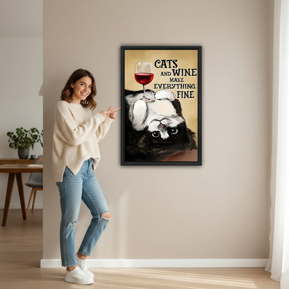 Smiling woman pointing at large cats and wine framed canvas print to show size in bright living room