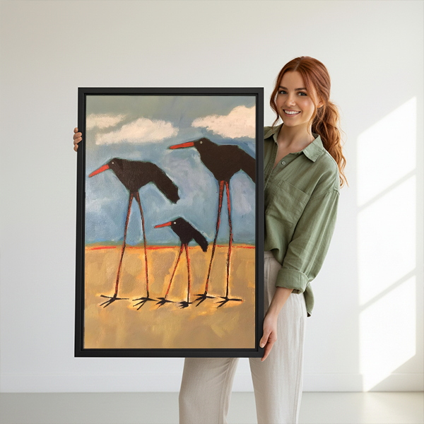 Smiling woman holding large shorebird family bold oil painting framed canvas print to show size against white background