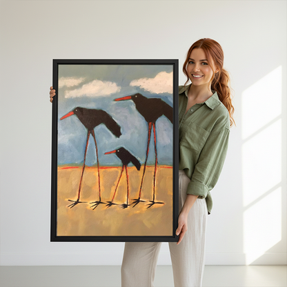 Smiling woman holding large shorebird family bold oil painting framed canvas print to show size against white background