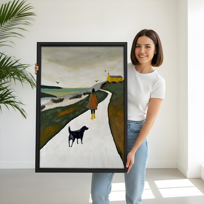 Woman holding large Nordic coastal walk woman dog framed canvas print, black frame, size reference lifestyle photo, moody landscape wall art
