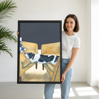 Woman holding large funny dog framed art print showing black and white dog on yellow armchairs size reference