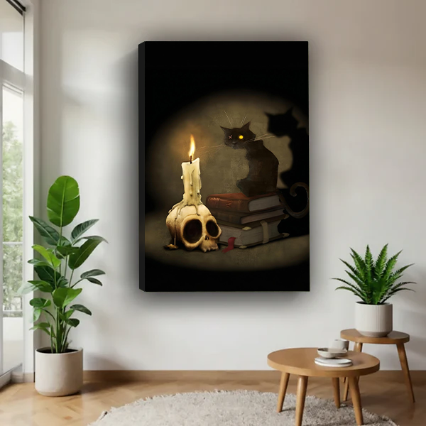 Woman holding black-framed gothic black cat canvas wall art featuring stacked books and a candle atop a skull.