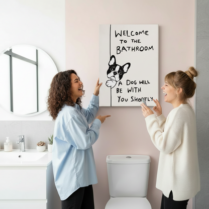 Two women laughing while hanging funny French Bulldog bathroom canvas print on pink wall