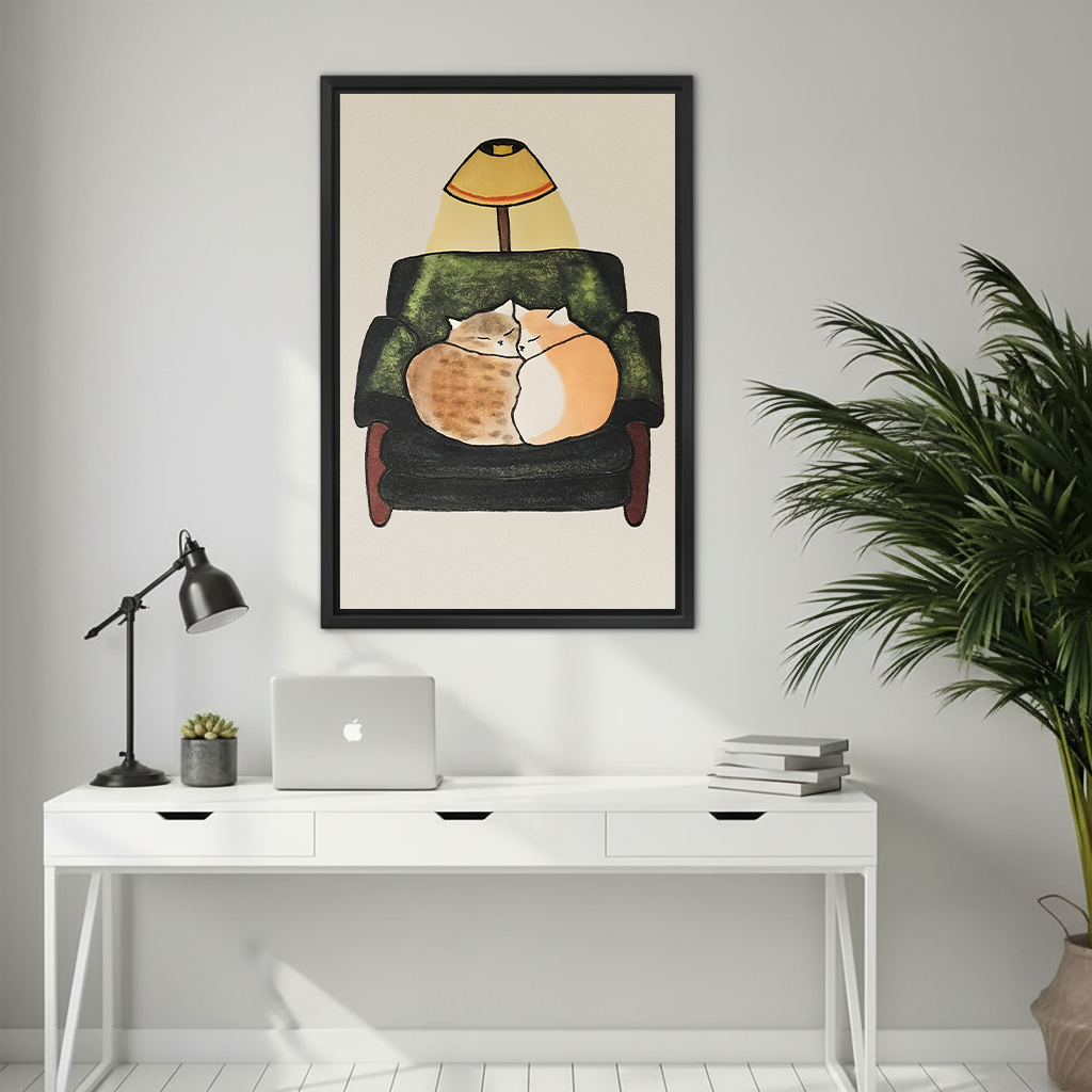 Two cats sleeping together in armchair warm lamp illustration framed canvas print above white desk in modern home office