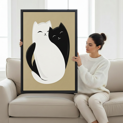 Woman holding large framed black and white cat yin yang illustration art print showing actual print size on cream sofa in bright living room