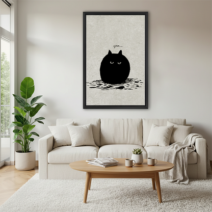Grumpy black cat minimalist funny framed canvas wall art above cream sofa in bright Scandinavian living room with round coffee table and throw blanket