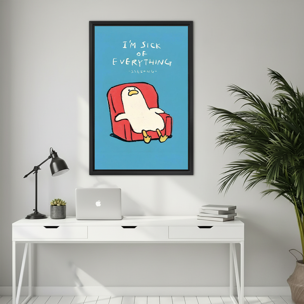White cartoon duck slouched in red armchair with I'm sick of everything handwritten text on blue background funny minimalist illustration framed wall art hung on light grey wall above white desk with MacBook black task lamp succulent and stacked books beside large palm plant
