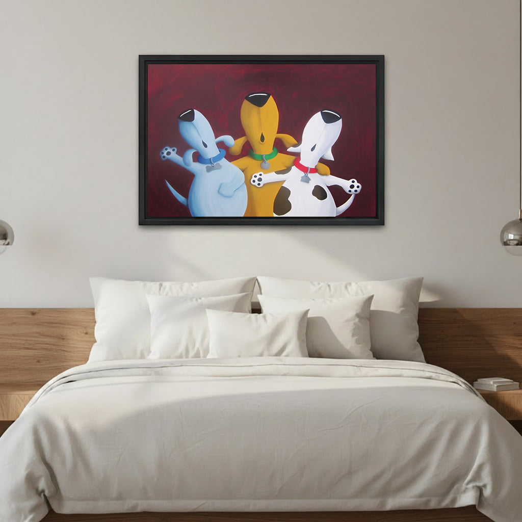 Whimsical three dogs best friends framed canvas wall art, blue yellow white cartoon dogs hugging, deep red background, black frame, above white linen bed with silver sconces