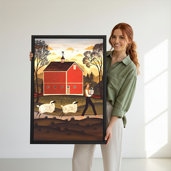 Red barn and sheep canvas wall art in a black frame beside a bed with woven headboard.
