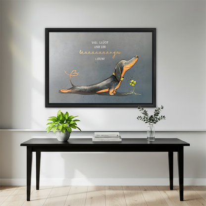 Humorous dachshund art print in black frame above minimalist black console table