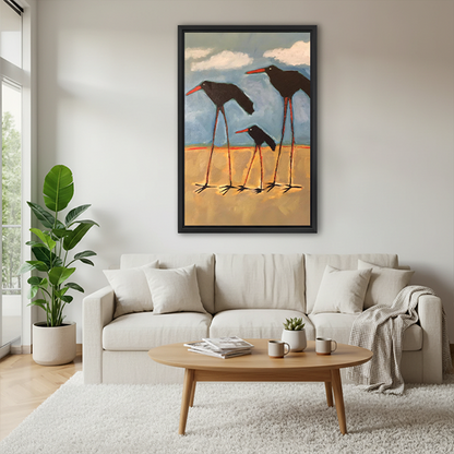Expressive shorebird family walking on beach framed wall art in black frame above cream sofa with round coffee table and throw blanket
