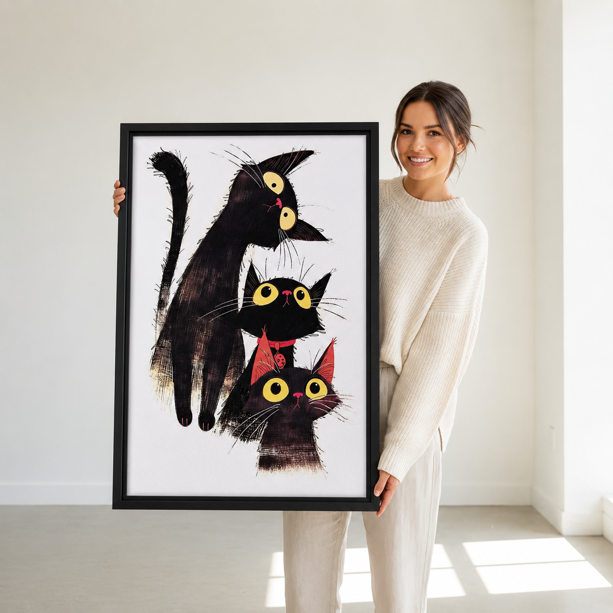 Three Stacked Black Cats Whimsical Framed Print Held by Person – Size Reference for Funny Cat Wall Art