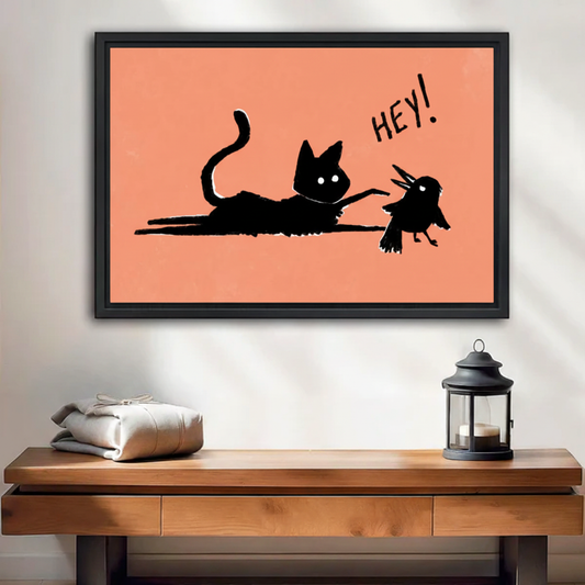 Hey! Black Cat and Bird Funny Canvas Wall Art — black framed print displayed on a living room wall