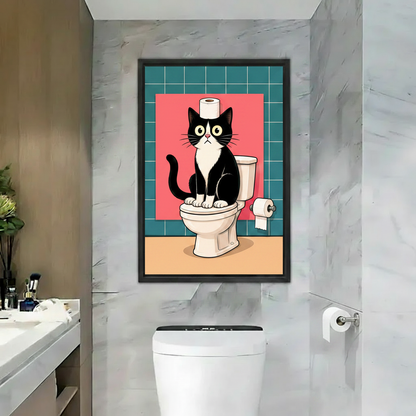 Funny black and white cat sitting on toilet canvas wall art print in black frame hanging in modern marble bathroom