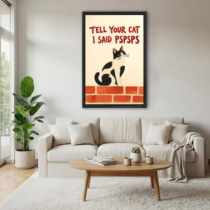 Black-framed funny cat canvas wall art reading Tell Your Cat I Said Pspsps displayed between indoor plants.
