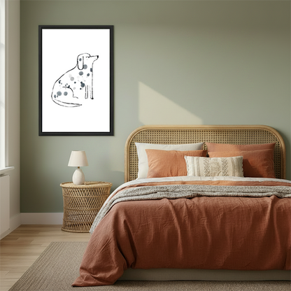Minimalist dalmatian spot art in black frame above rattan bed with terracotta bedding in sage green boho bedroom