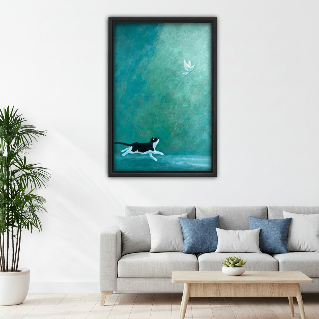 Black and white cat chasing white bird framed art print, black frame, teal oil painting style, hung above a grey linen sofa in a bright Scandinavian living room with indoor palm
