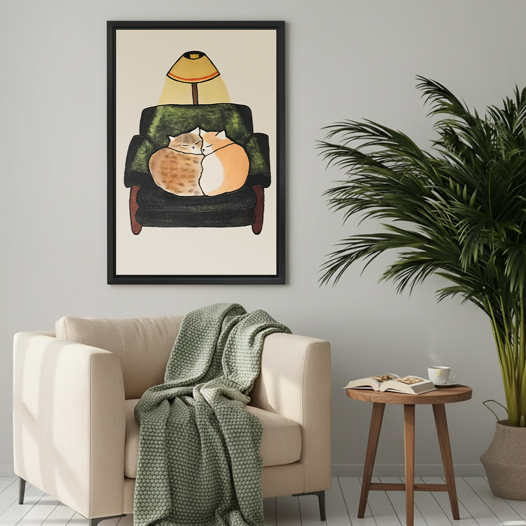 Two cats cuddling in green armchair cozy illustration framed wall art above cream sofa with knit throw blanket