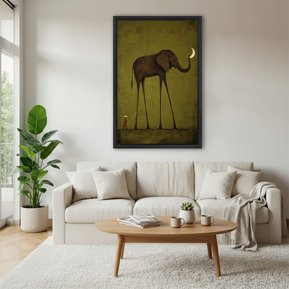 Surreal elephant moon canvas wall art in a black frame displayed between indoor plants beside wooden tables.