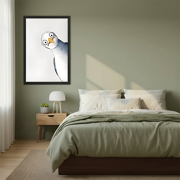 Tilted seagull watercolor framed wall art with wide-eyed quirky bird hung on sage green wall above wooden bed with linen bedding in Scandinavian bedroom