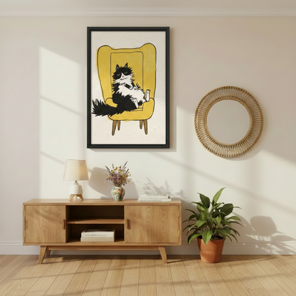 Grumpy black and white cat lounging in mustard yellow chair funny wall art print in black frame above oak media console with lavender vase and rattan round mirror in Scandinavian living room