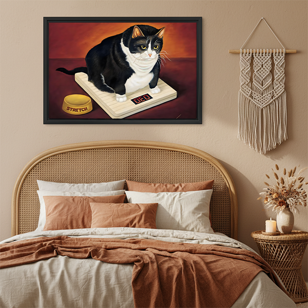 Humorous fat cat on scale framed canvas art hanging above boho bedroom bed