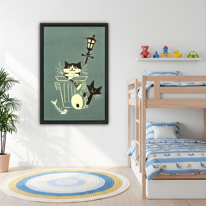 Whimsical alley cats canvas wall art in a black frame above a dining table, with cream details on sage green.