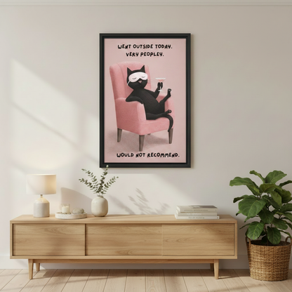 Funny black cat very peopley would not recommend wall art print in black frame above wooden sideboard with ceramic vases and green plant in Scandinavian entryway