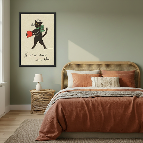 Framed French vintage black cat heart illustration above a boho bedroom bed with terracotta bedding, romantic cat wall art for bedroom