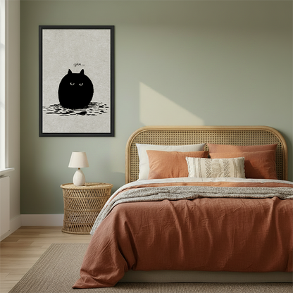 Round grumpy black cat grrr minimalist framed canvas wall art hanging in cozy boho bedroom above rattan bed with terracotta bedding and rattan nightstand