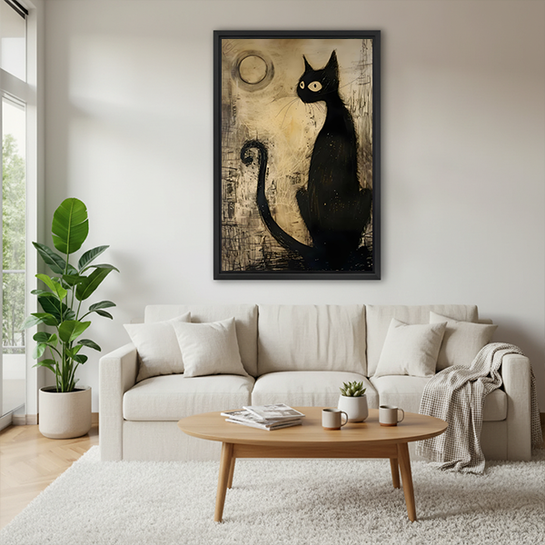Framed black cat canvas wall art above a sofa, showing a sleek cat beneath a pale moon