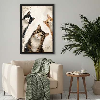 Whimsical watercolor cat trio framed wall art print above a cozy beige armchair in a neutral living room