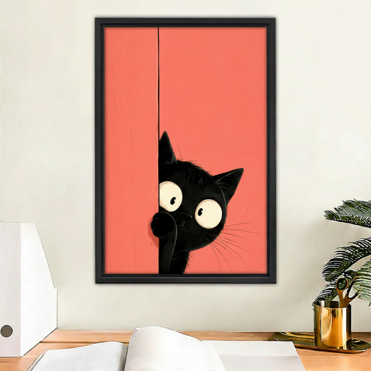 Peeking black cat framed canvas wall art print on coral red background above desk