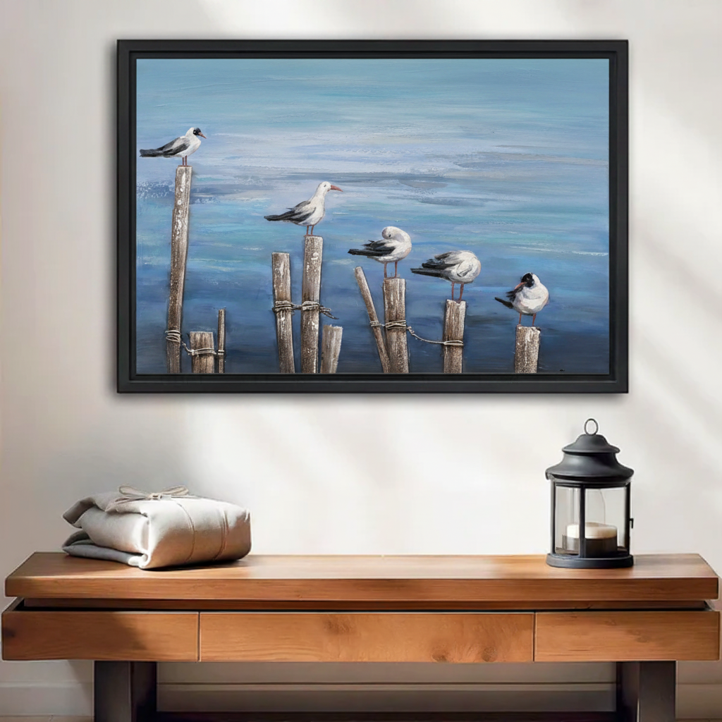 Coastal oil painting of seagulls perched on wooden pier posts framed canvas wall art above entryway console, beach house decor