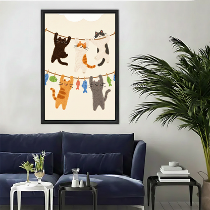 Cute cats on clothesline framed canvas wall art print above navy blue sofa in modern living room