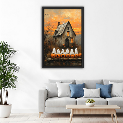 Framed Halloween ghost cottage canvas wall art with a weathered house and glowing pumpkins above a dining table.