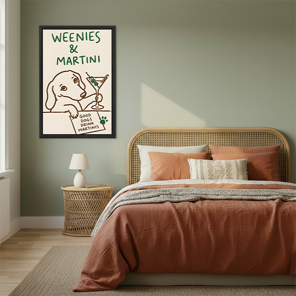 Framed dachshund martini wall art hanging above a cream sofa with a round wooden coffee table