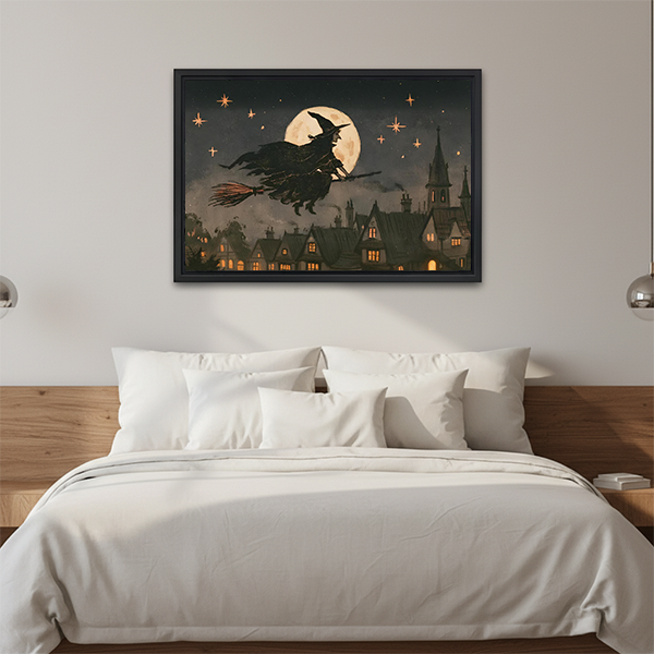 Gallery-wrapped moonlit witch canvas wall art above a wooden console table, featuring a golden full moon and dark village.