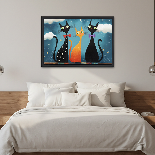 Gallery-wrap whimsical three cat night canvas wall art above a wooden console in a bright room