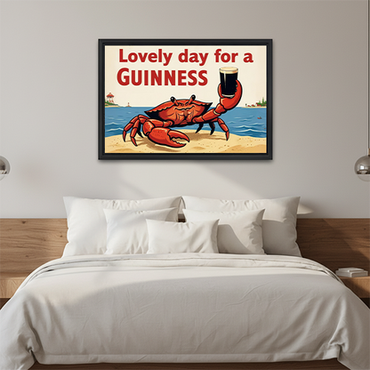 Black-framed Guinness crab canvas wall art above a wooden console with folded blankets and a black lantern.