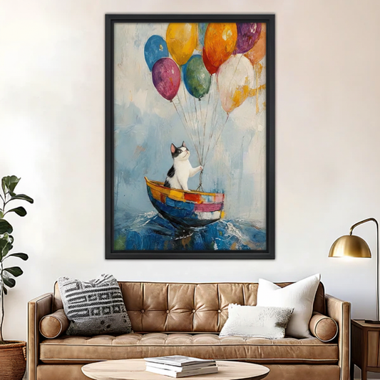 Whimsical cat balloon boat canvas wall art print in black frame hanging above brown leather sofa in modern living room