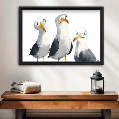 Whimsical seagull trio framed canvas wall art with black float frame above a wooden console table