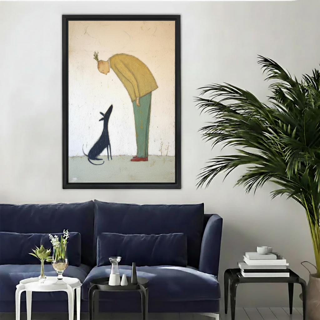 Man in yellow sweater bending to black dog minimalist whimsical wall art print in black frame above navy velvet sofa with white side table and black coffee table in modern living room