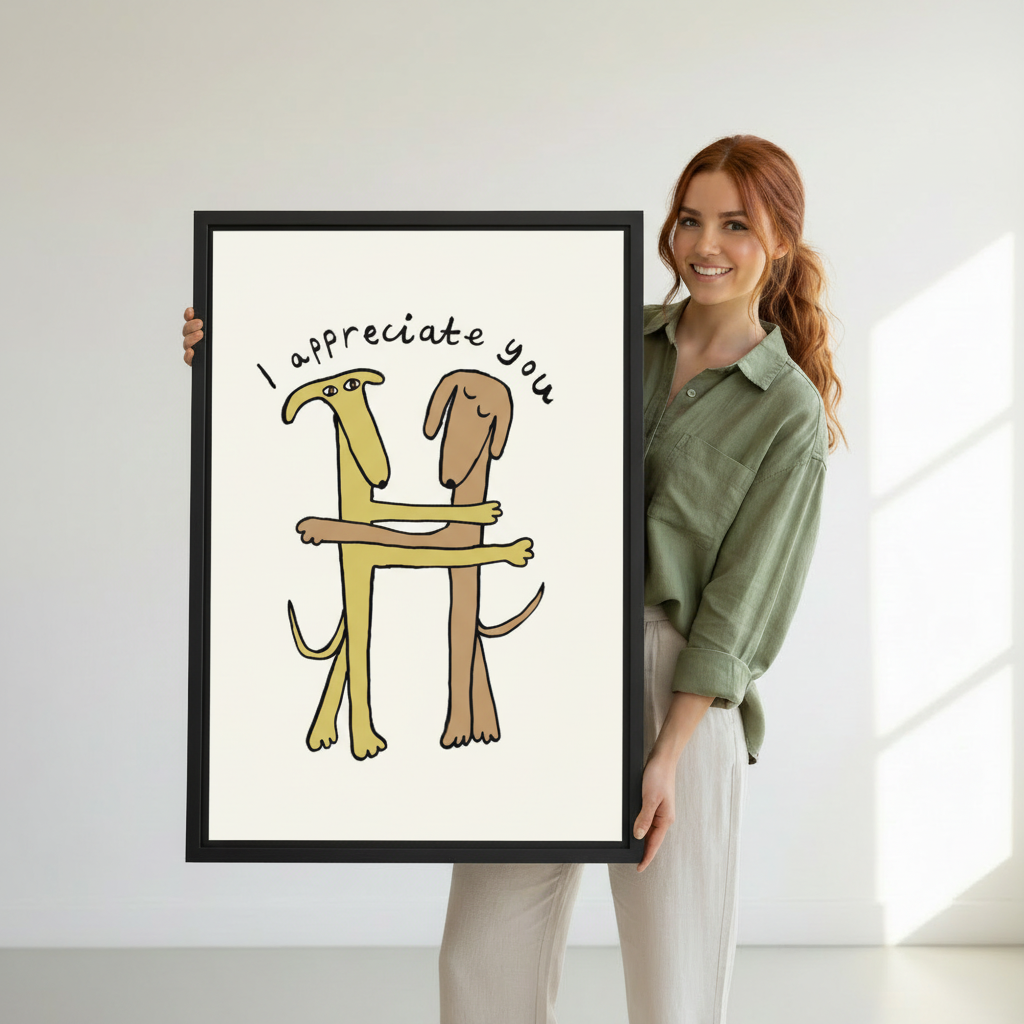 Woman holding large framed "I Appreciate You" funny dogs hugging wall art print, black frame, whimsical cartoon illustration on cream background, showing actual print size in a bright modern studio