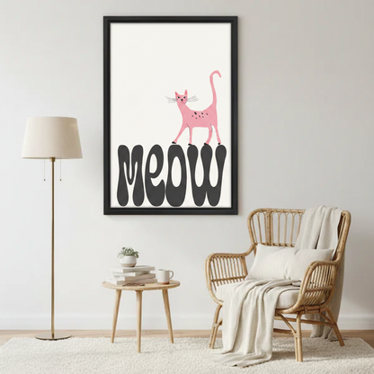 Cute pink cat meow retro typography wall art print in black frame beside rattan armchair with cream throw and gold floor lamp in cozy reading nook