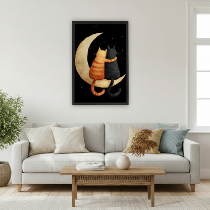 Romantic orange tabby and black cat on crescent moon wall art print in black frame above light grey sofa with pampas grass vase in Scandinavian living room