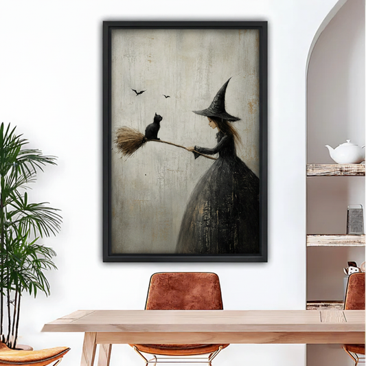 Vintage witch and black cat canvas wall art in black frame above dining table, moody folk art print for gothic modern home decor